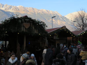 Massive peaks form the backdrop of the Christmas market in Innsbruck, Austria